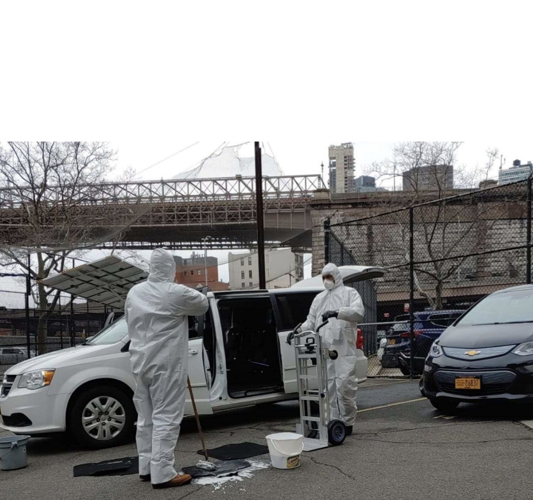 Crew in PPE servicing a van near the Brooklyn Bridge