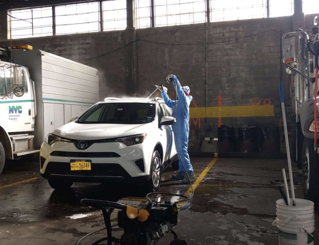 Pressure washing an NYC fleet SUV in the garage