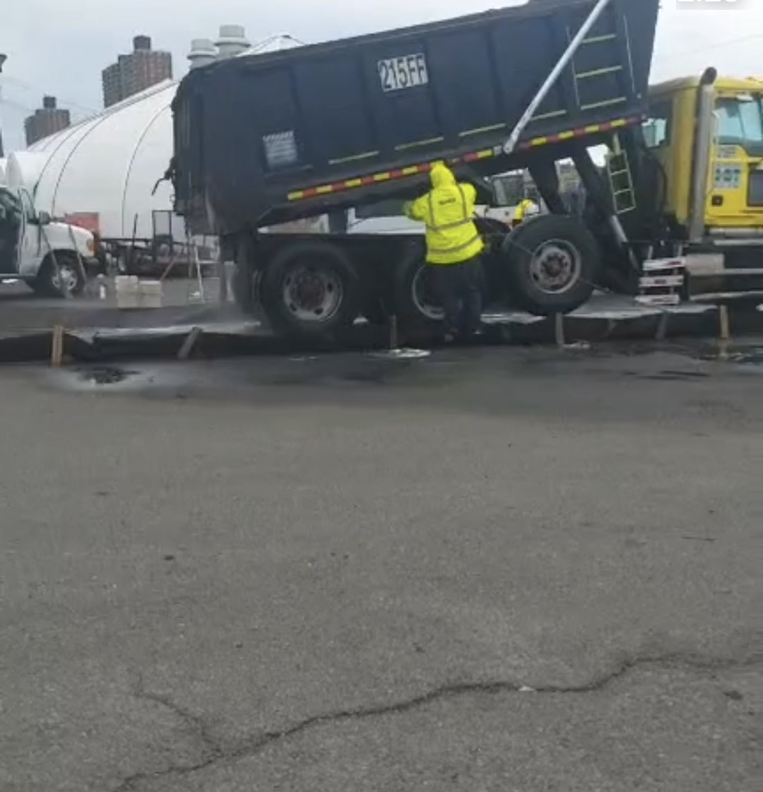 Crew servicing a dump truck