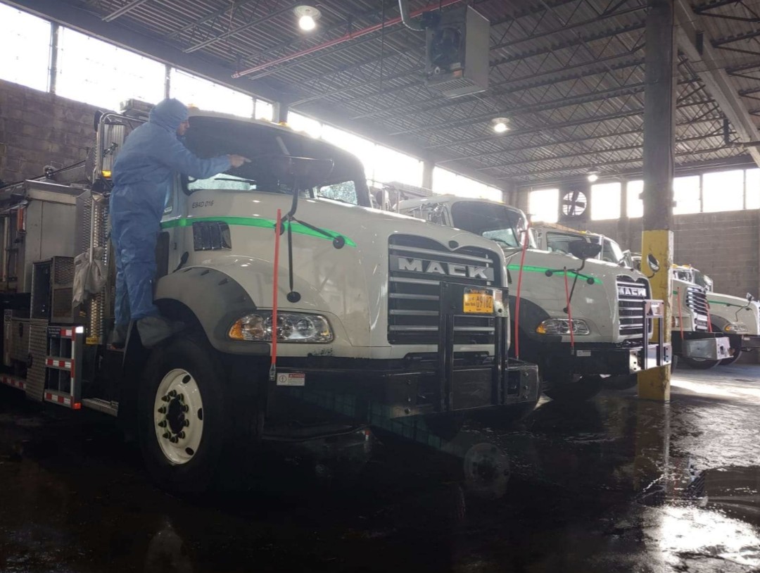 Technician detailing a Mack truck interior